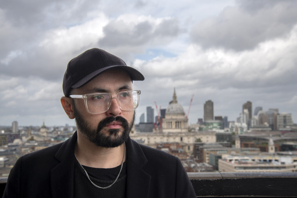 Fotografía de Tomás Brantmayer viendo al horizonte con una ciudad de fondo