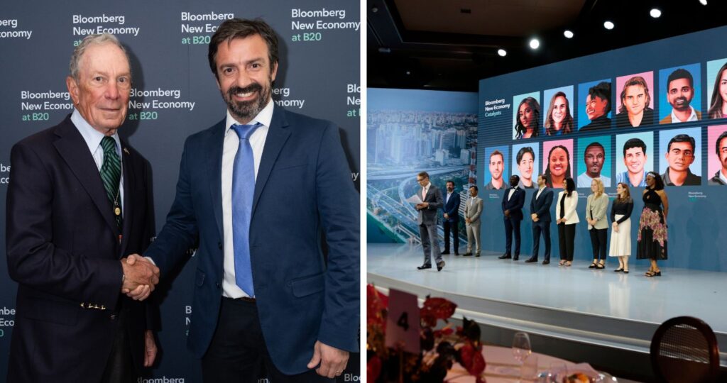 Gráfica del alumni UC, Gonzalo Vial, estrechando la mano de otro hombre tras reconocimiento de Bloomberg New Economy Catalysts